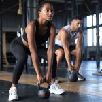 fit-muscular-couple-focused-lifting-dumbbell-during-exercise-class-gym (1)